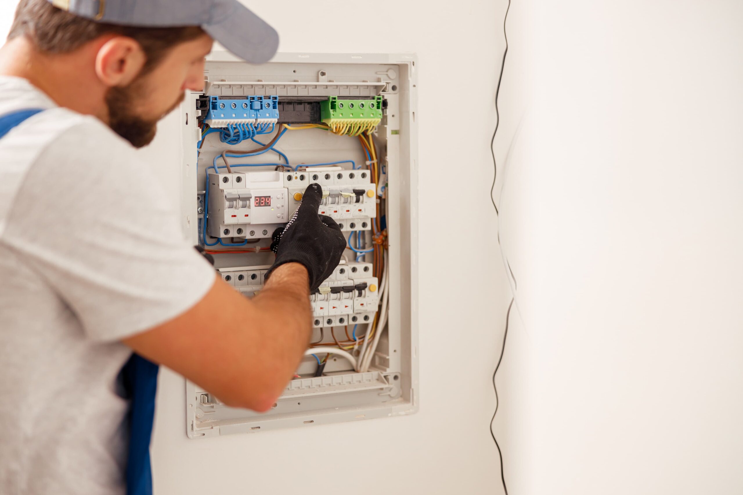 electrical technician in uniform looking focused