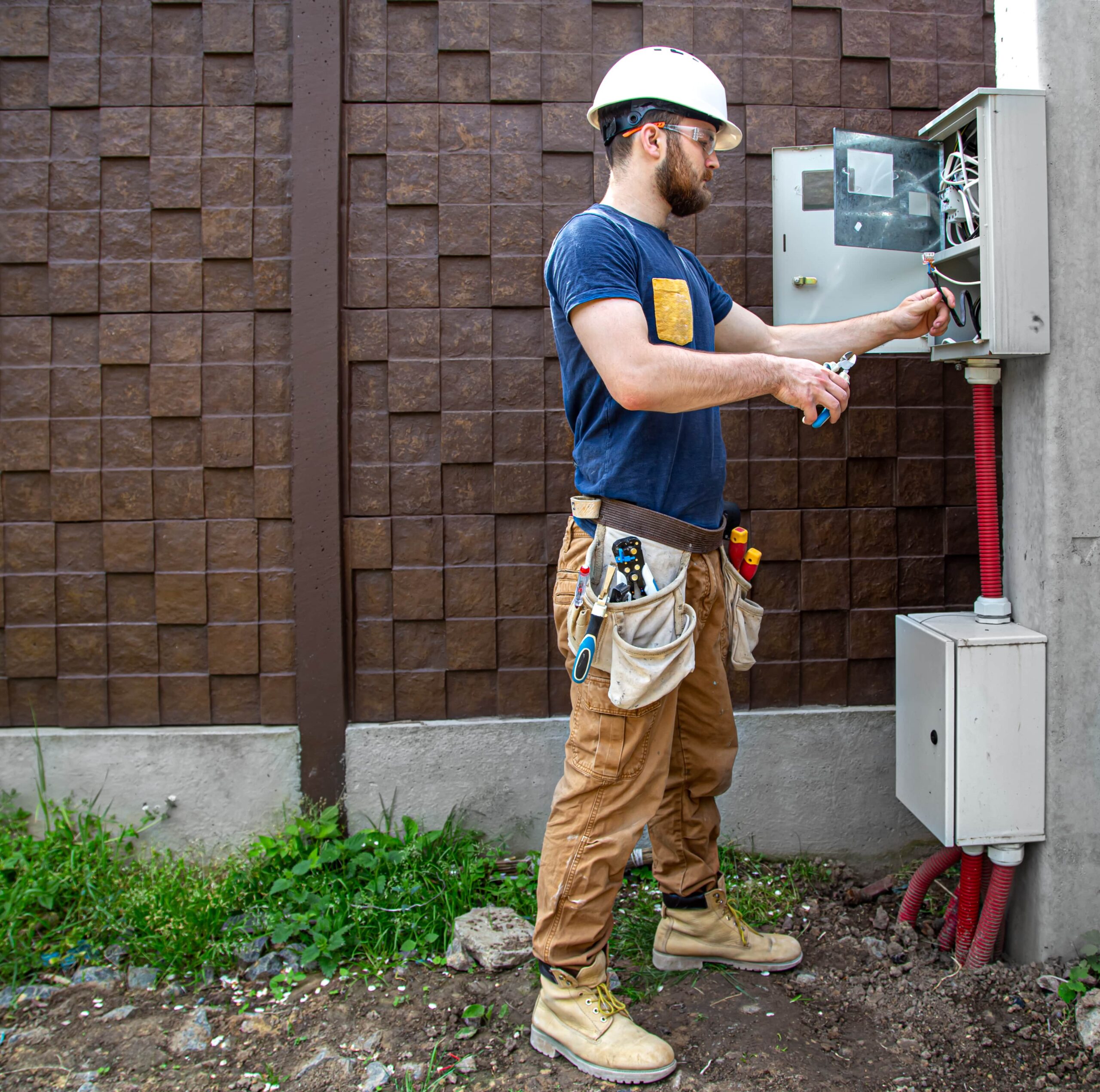 electrician builder at work examines cables