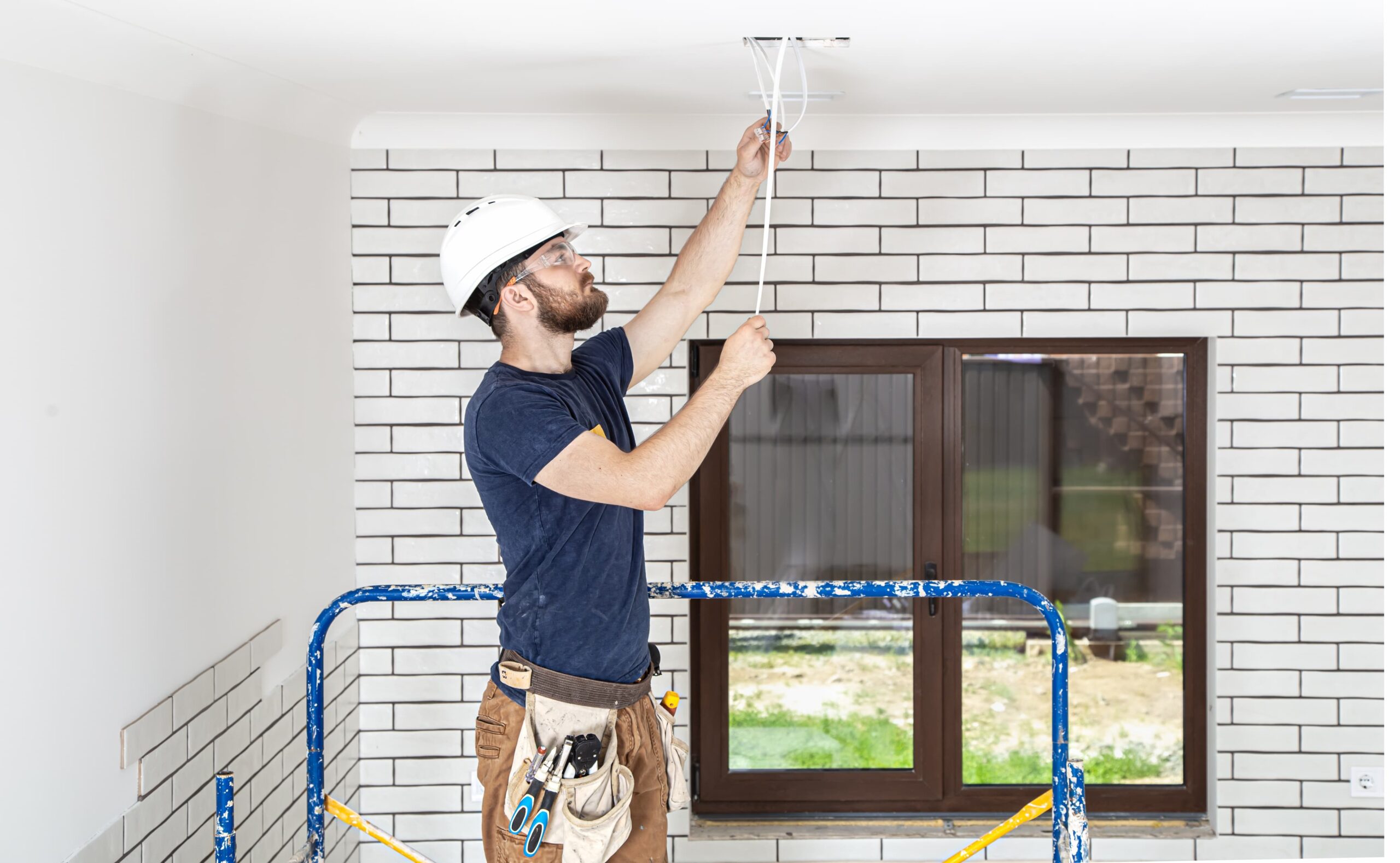 electrician builder at work installation of lamps