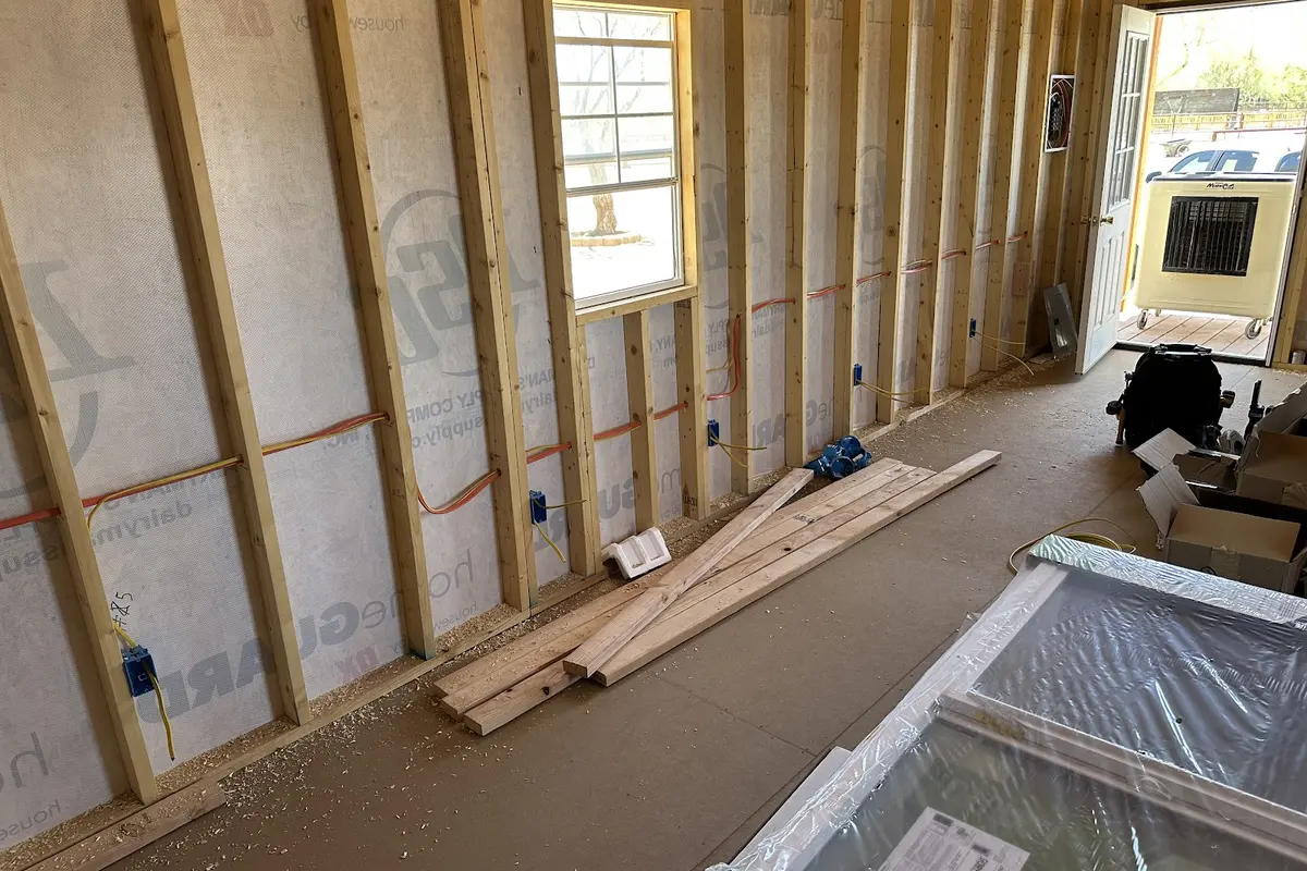 Framed room with exposed wall studs before electrical rough-in and drywall