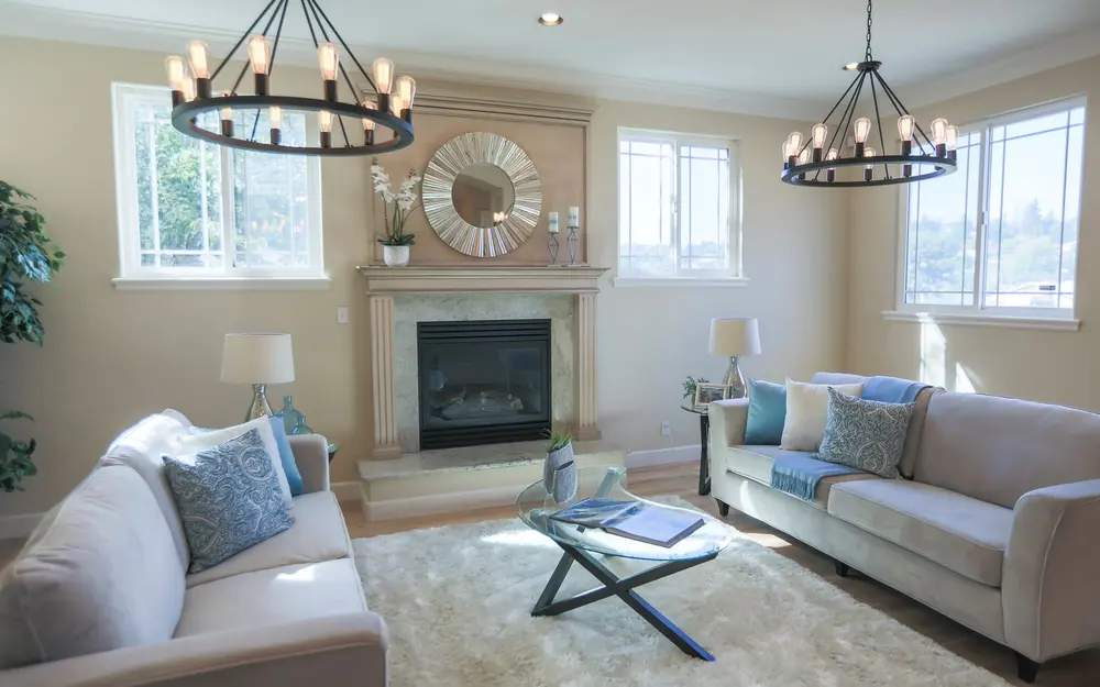 Bright living room with lit chandeliers and lamps in a suburban home after power is restored